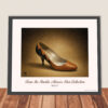 Framed Bally Cinnamon Leather Pumps art print from the Imelda Marcos Shoe Collection displayed leaning against a wall in a contemporary interior.