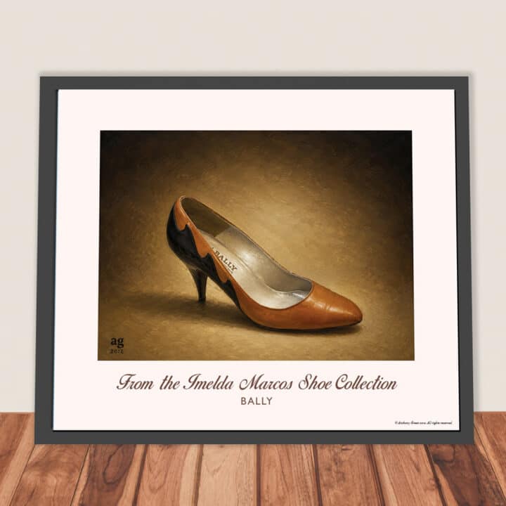 Framed Bally Cinnamon Leather Pumps art print from the Imelda Marcos Shoe Collection displayed leaning against a wall in a contemporary interior.