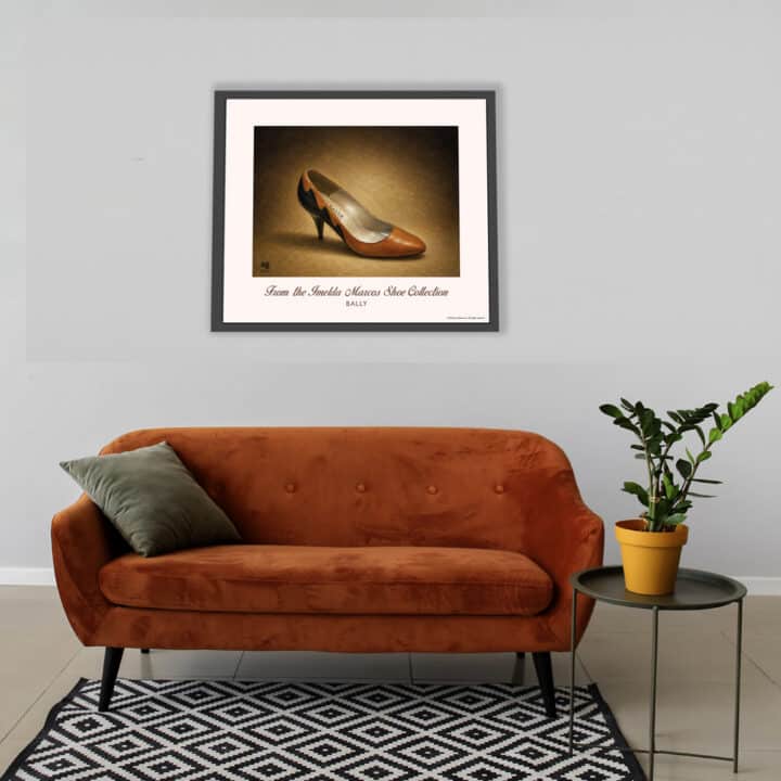 Framed Bally Cinnamon Leather Pumps art print from the famous Imelda Marcos Shoe Collection displayed above a sofa in a contemporary living room.