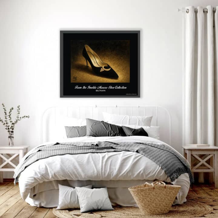 Framed Beltrami shoe print from the Imelda Marcos Shoe Collection displayed as museum-quality wall art above a bed in a contemporary bedroom.