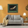 Framed Fendi Imelda Marcos shoe print displayed above a sofa in an orange contemporary room setting