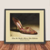 Framed Manolo Blahnik shoe print of red satin tapestry embroidered heels with gold floral piping, shown ready for wall hanging.