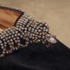 Close-up of Manolo Blahnik Rhinestone Heels showing crystal embellishment and scalloped detailing on black silk