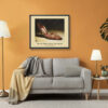 Framed Manolo Blahnik shoe print of red satin tapestry embroidered heels with gold floral detailing displayed in a contemporary living room.
