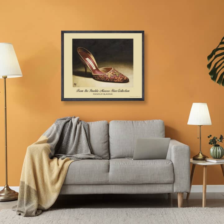 Framed Manolo Blahnik shoe print of red satin tapestry embroidered heels with gold floral detailing displayed in a contemporary living room.