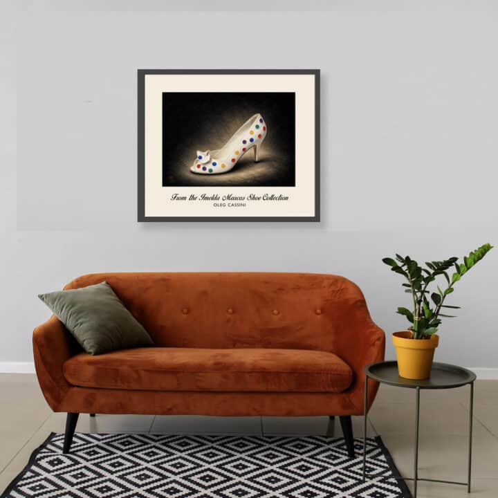 Oleg Cassini Polkadot Pumps art print displayed above an orange sofa, featuring white leather, multicoloured dots and decorative bow