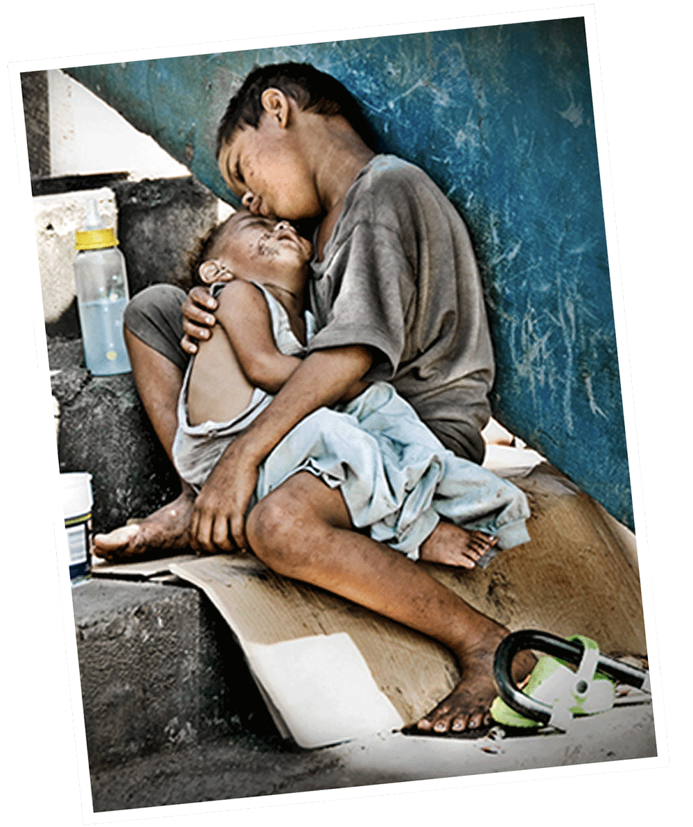 Two vulnerable street children living in Manila, Philippines. Every museum-quality art print from the Imelda Marcos Shoe Collection sold by Sole Support donates £19 to help children in extreme poverty.