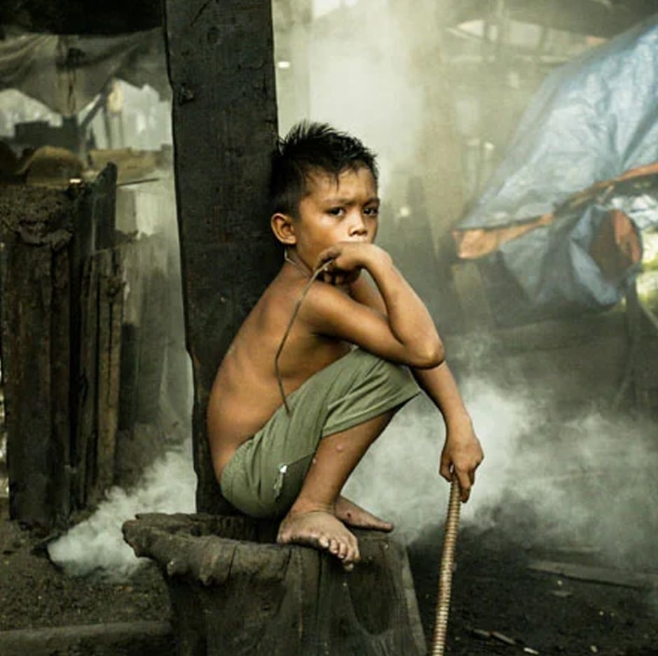 Young child living in poverty in an informal settlement in Manila, Philippines