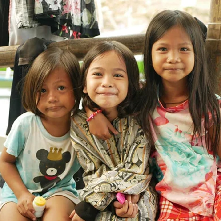 Three young children from an impoverished community in Manila, Philippines