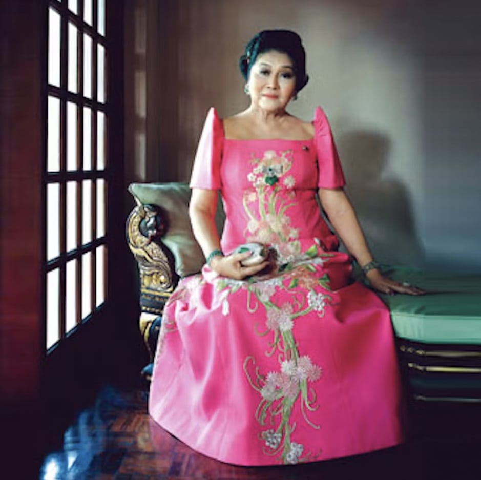 Imelda Marcos wearing a formal red terno dress in Manila, Philippines